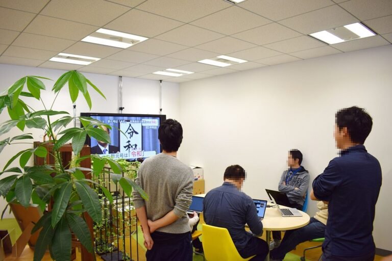 office workers checking documents on laptops