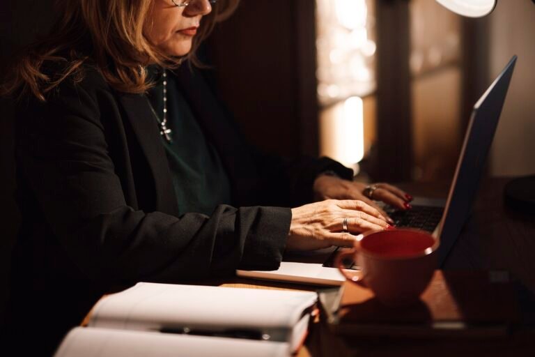 Businesswoman reviewing figures on a laptop in an office